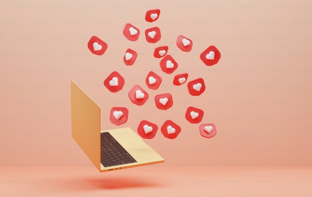 Laptop with engagement icons — Meta Ads creative testing, hooks, and social performance